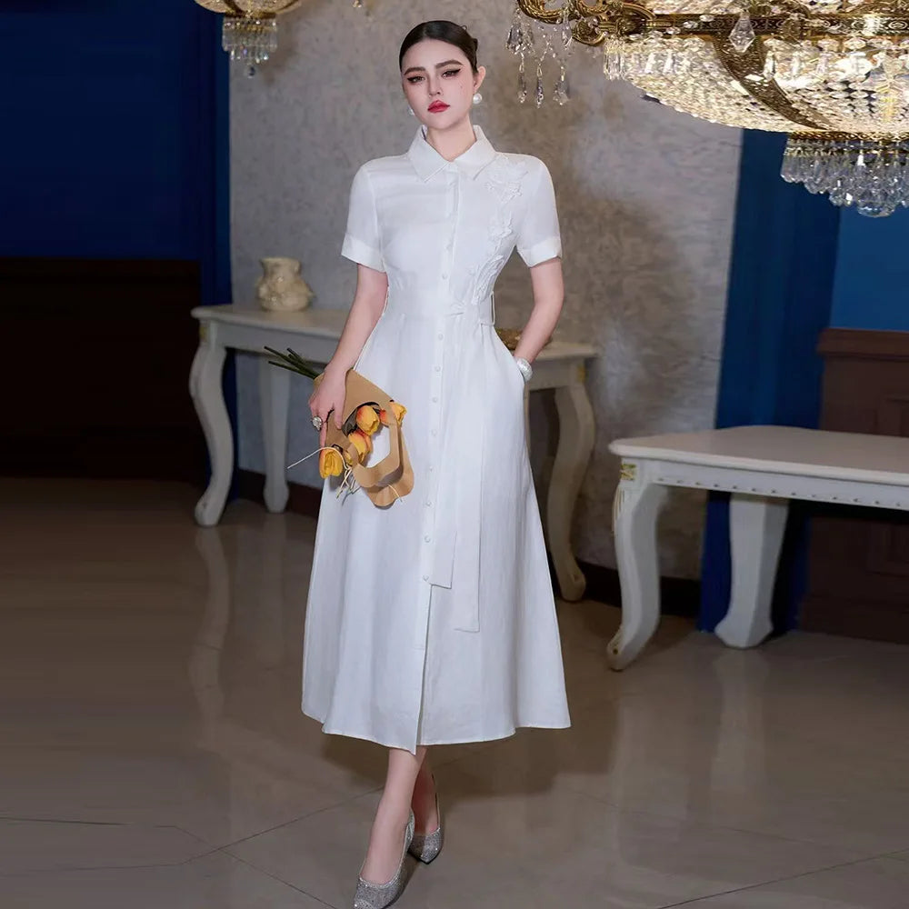 Robe longue pour femme au style élégant français, col polo, manches courtes, fleurs 3D, simple-boutonnage, taille haute avec nœud et lacets (Collection Printemps 2026)