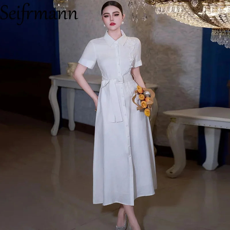 Nouvelle robe longue femme tendance été 2026 Seifrmann à revers, manches courtes, simple boutonnage, avec ceinture et taille cintrée